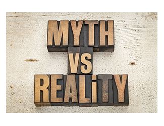 myth versus reality - concept in vintage letterpress wood type on a grunge painted barn wood background
